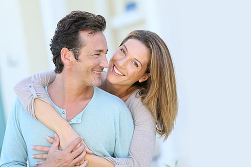 500x332 0004 Middle Aged Couple Embracing In Front Of House